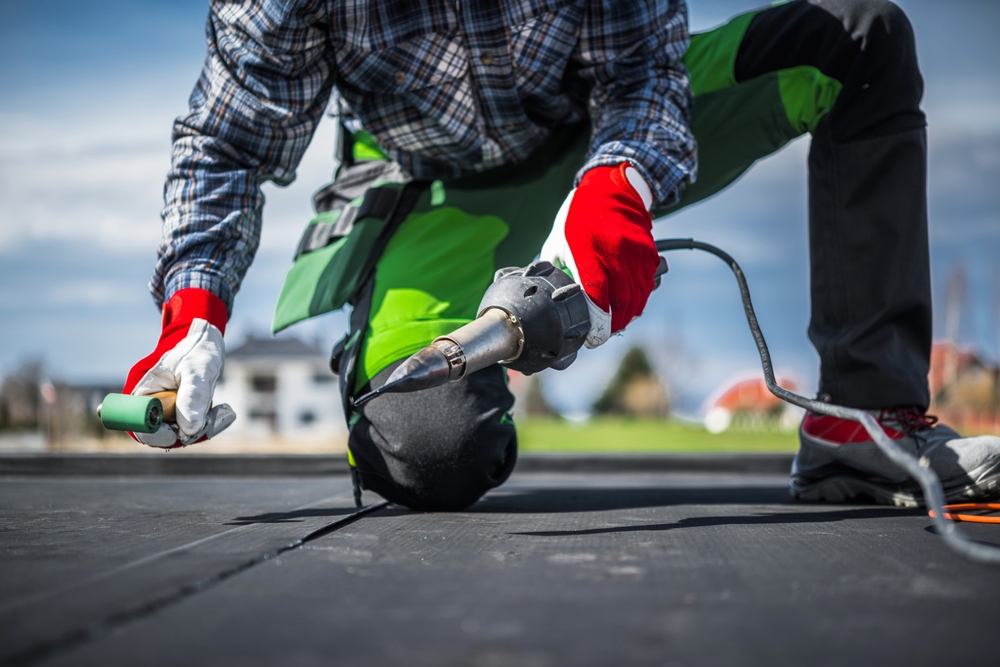 EPDM membrane installation using a hot air blower, featuring ethylene propylene diene terpolymer for roofing technologies